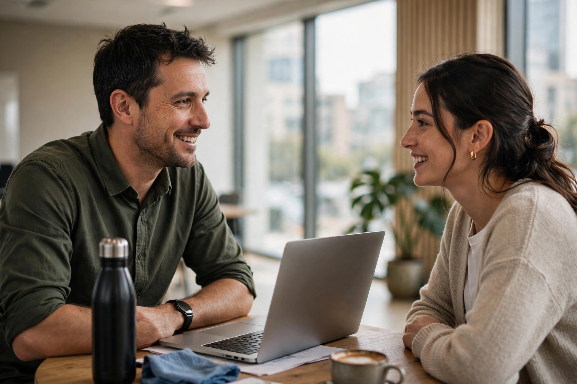 Friendly one-to-one meeting between a manager and team member at a small office table